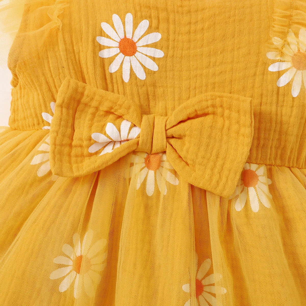 Cute summer dress for baby girls with cheerful daisy pattern featuring its bow