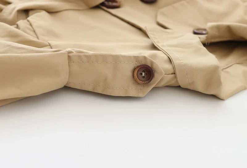 Baby girl's stylish beige trench coat with belt and buttons – perfect autumn and winter outerwear