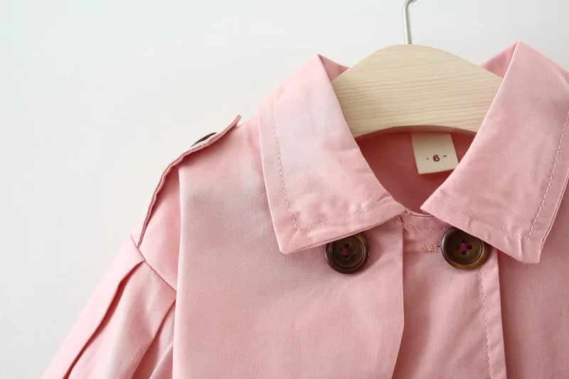 Baby girl's stylish pink trench coat with belt and buttons – perfect autumn and winter outerwear.