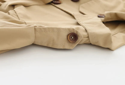 Baby girl's stylish beige trench coat with belt and buttons – perfect autumn and winter outerwear