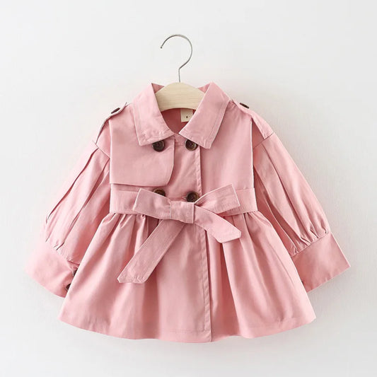 Baby girl's stylish pink trench coat with belt and buttons – perfect autumn and winter outerwear.
