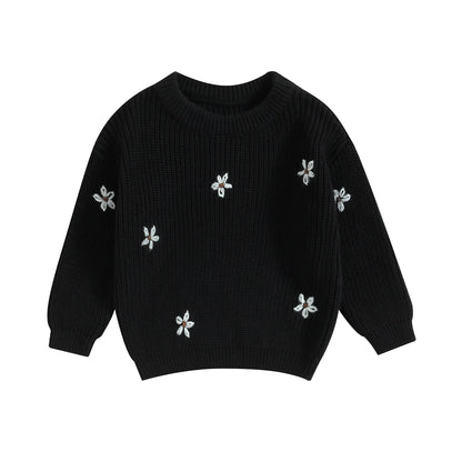 A soft knitted sweater with colourful flower print, round neck and full sleeves.