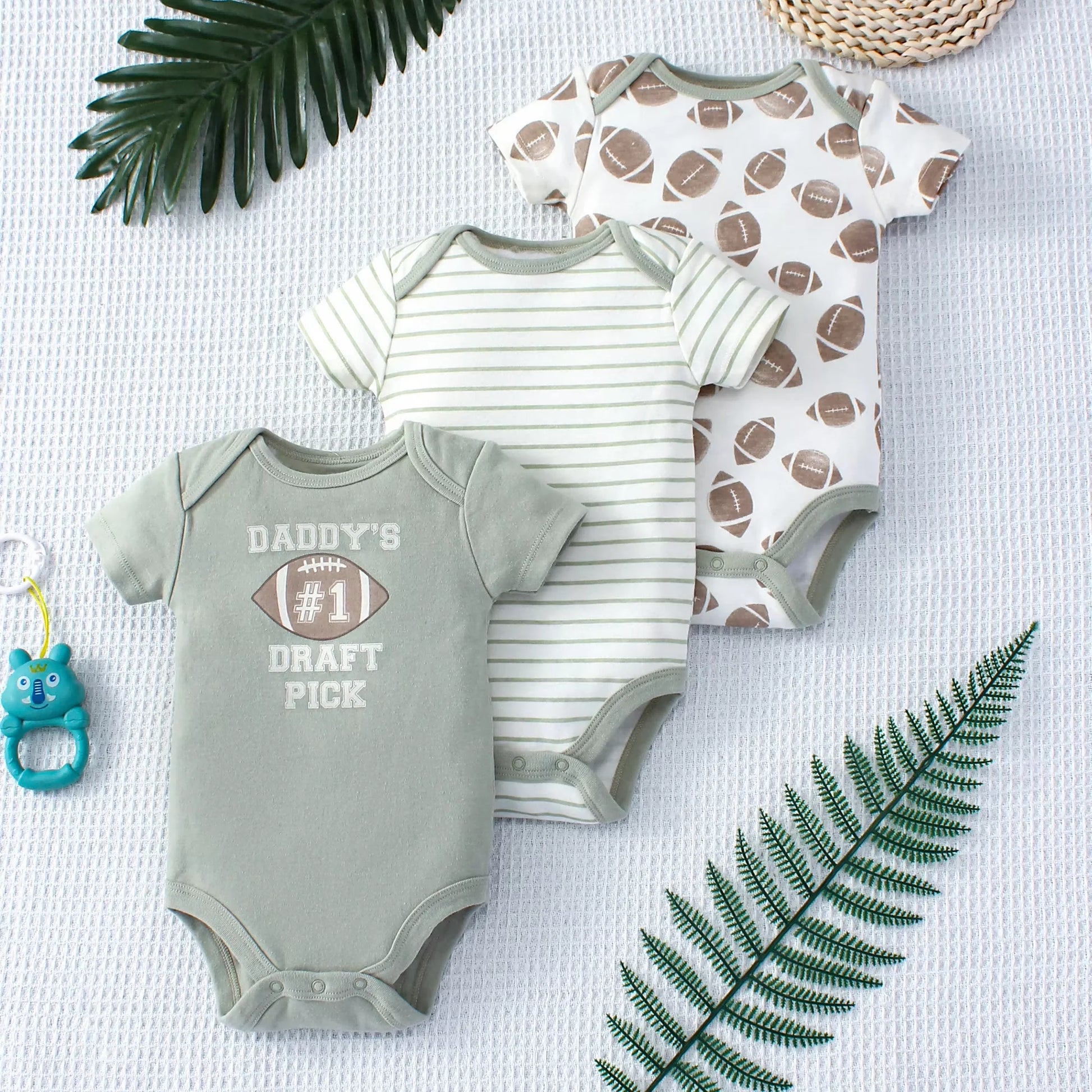 Set of three Daddy’s Pick baby bodysuits – soft cotton onesies with playful sports-themed prints