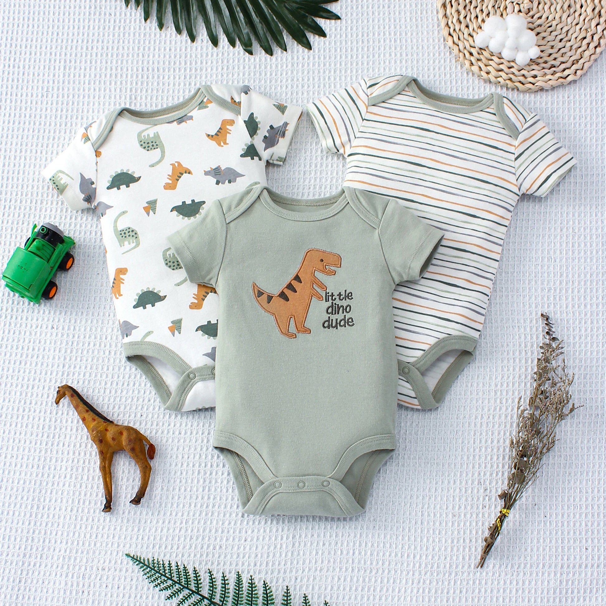 Set of three dino baby bodysuits – soft cotton onesies with playful dinosaur prints