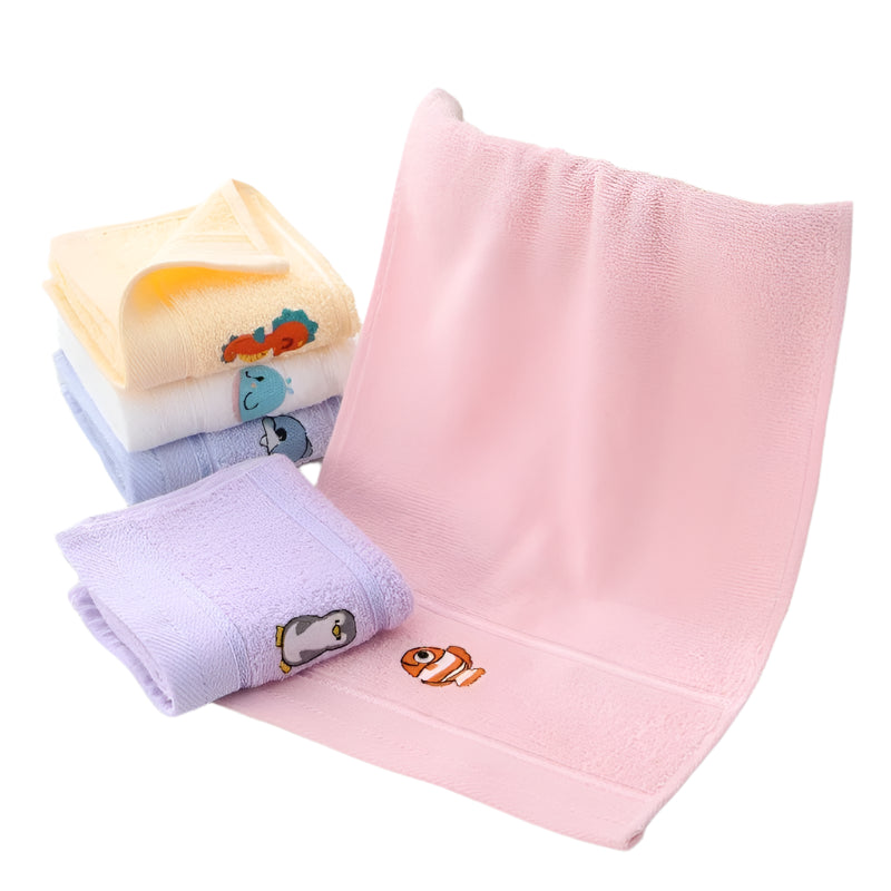 Stack of folded bath towels for babies with visible cartoon character designs, in pink, blue and yellow colors.
